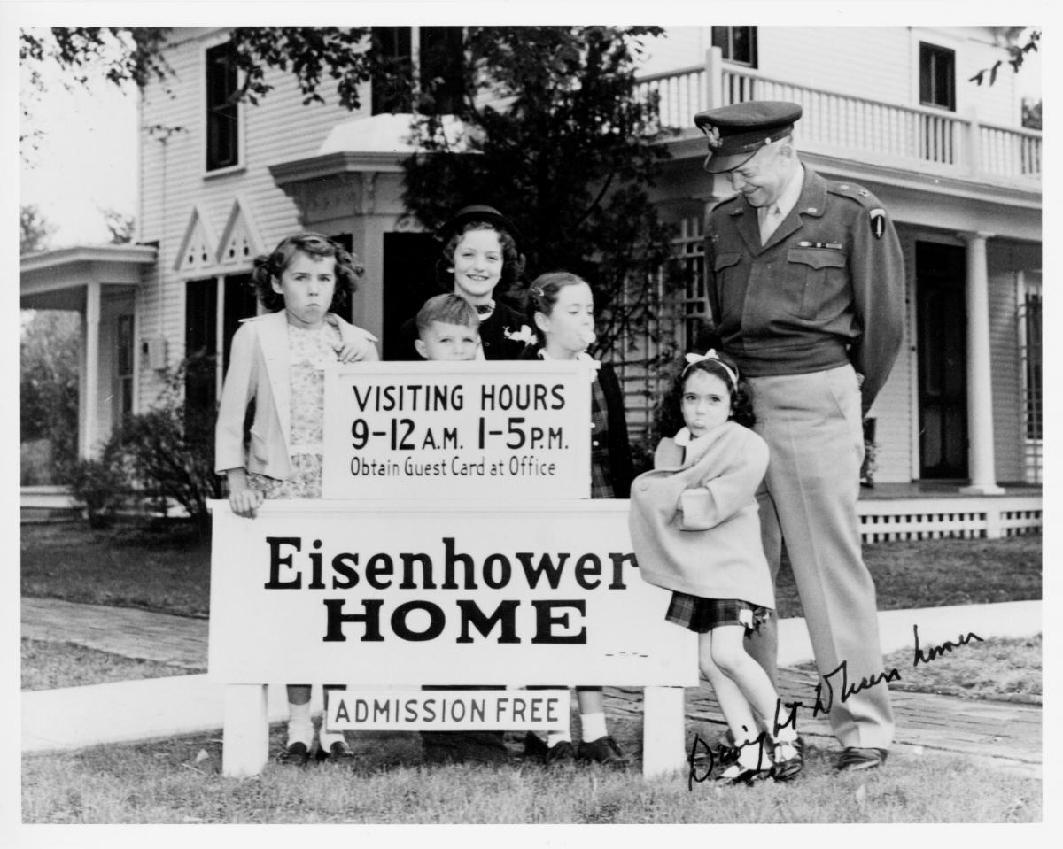 Image of Dwight Eisenhower with neighborhood children in 1947 in front of the home