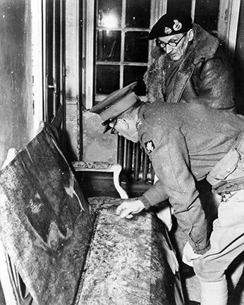 Ardennes-Battle of the Bulge. January 3,1945 - Major General Thomas, Commander British 30th Corps, and Field Marshal Bernard Montgomery study situation maps at VII Corps Headquarters in Belgium.